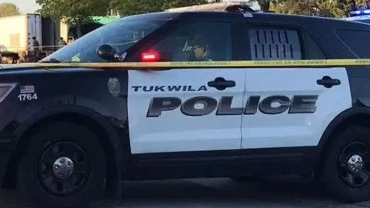 Tukwila Police Department SUV parked with yellow police tape in front, crime scene setting.