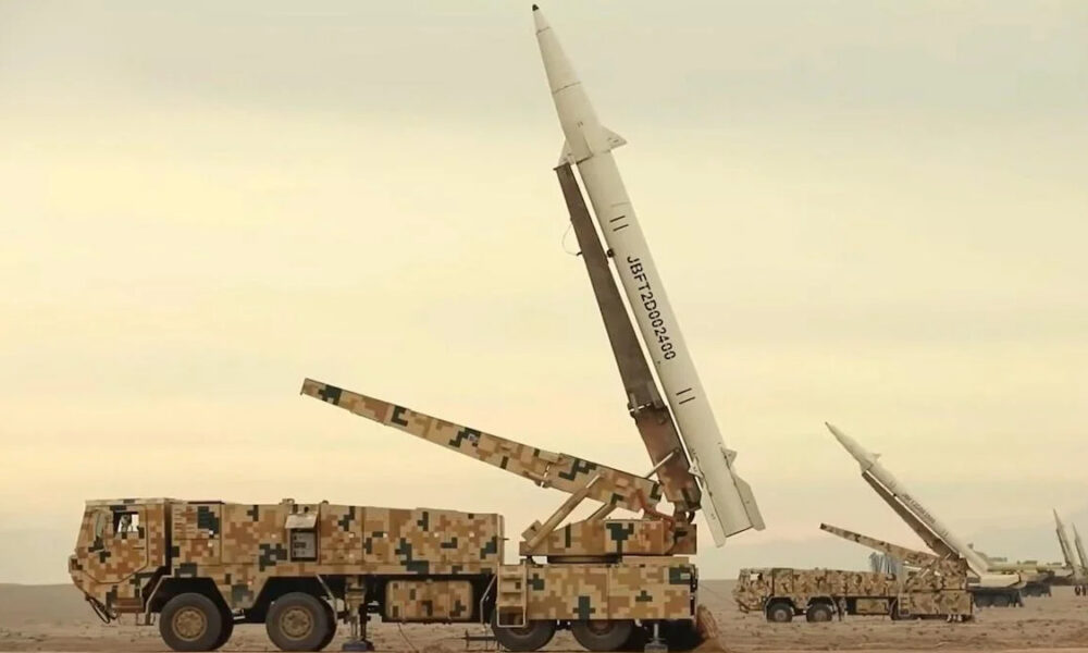 Camouflaged military trucks in a desert with large missiles mounted on launch rails, ready for launch.
