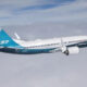 Boeing 737 MAX in flight with blue-turquoise tail and white fuselage, engine visible under the wing.